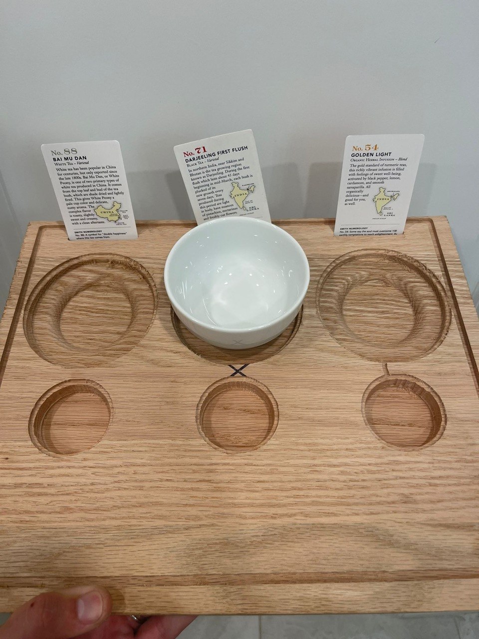 CNC routed oak tea flight board with recessed cup pockets
