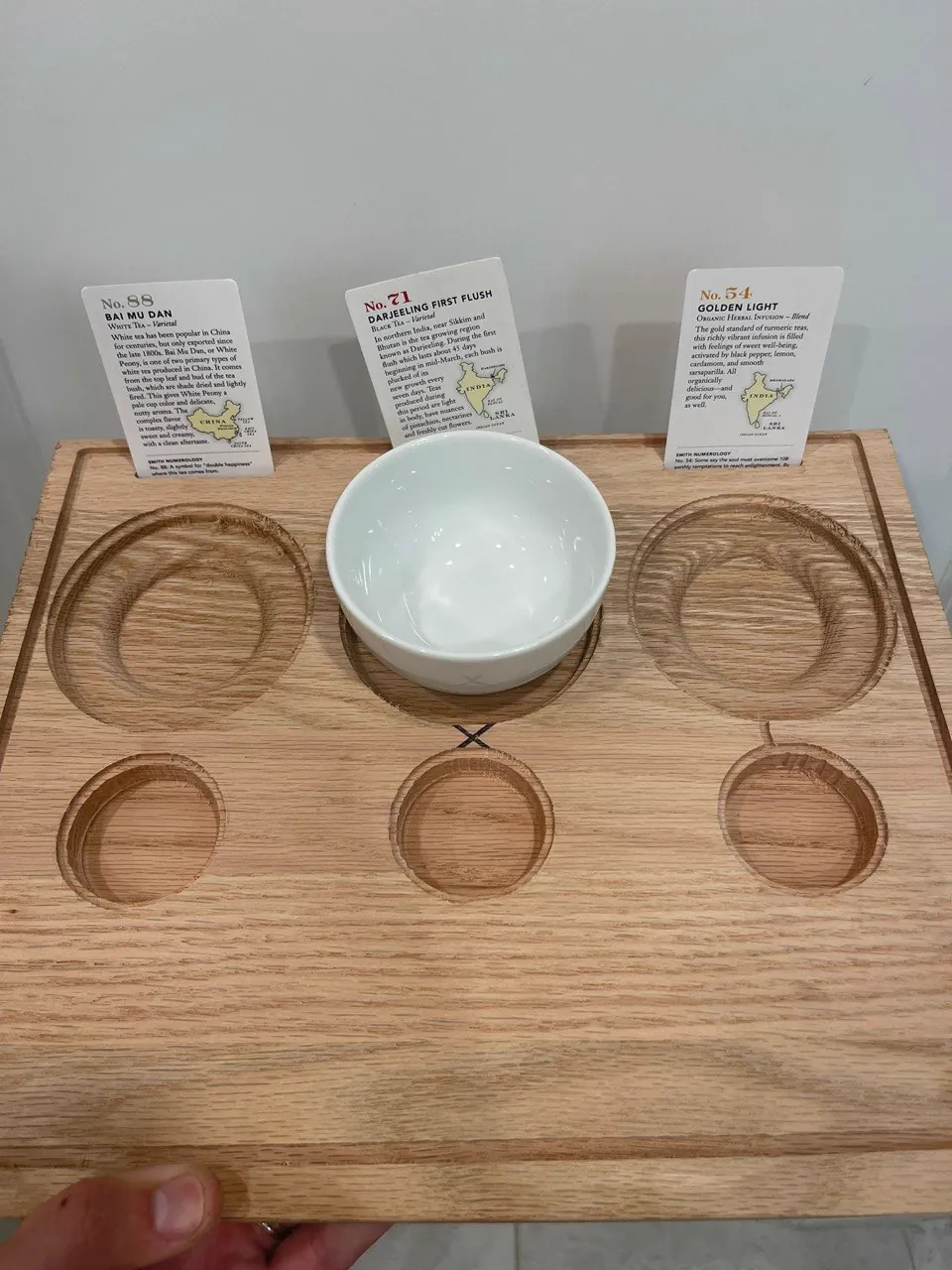CNC routed oak tea flight board with recessed cup pockets