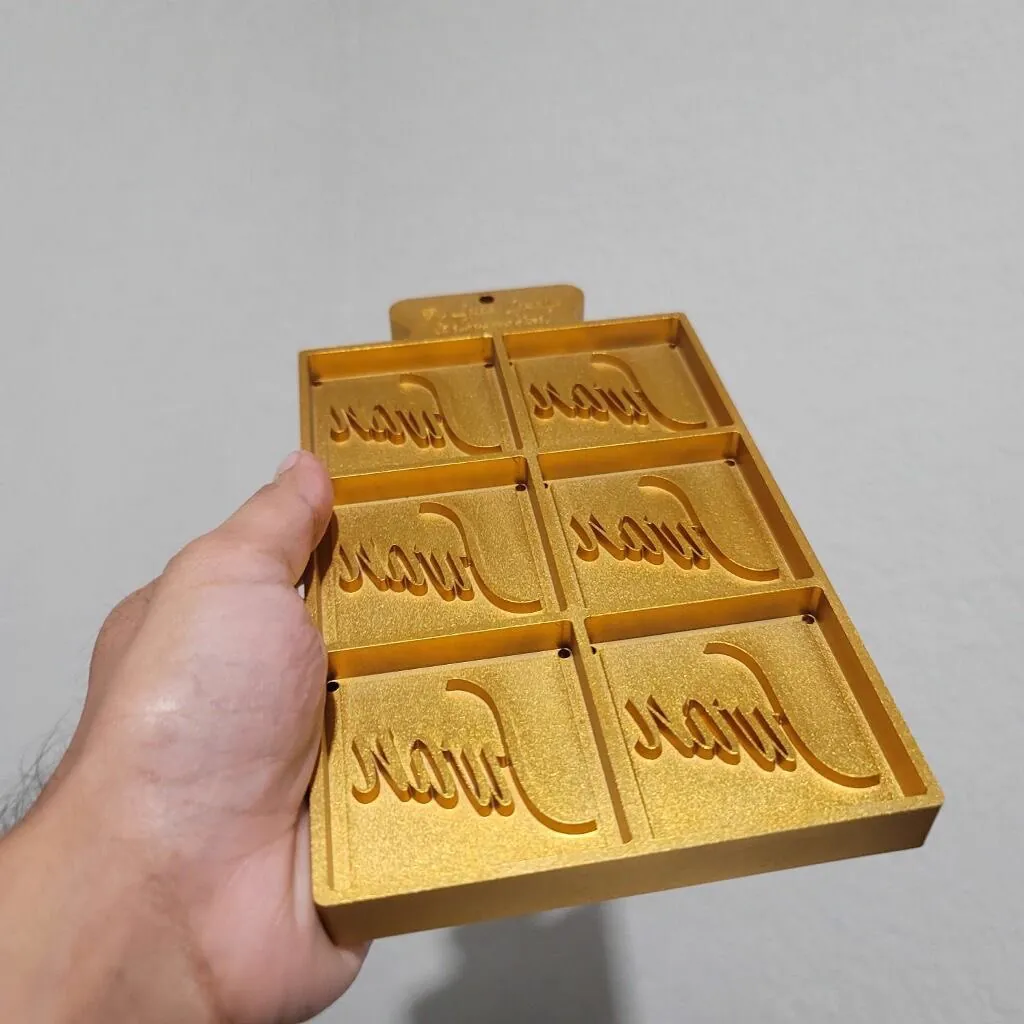 Gold painted six-cavity mold tray with recessed script lettering