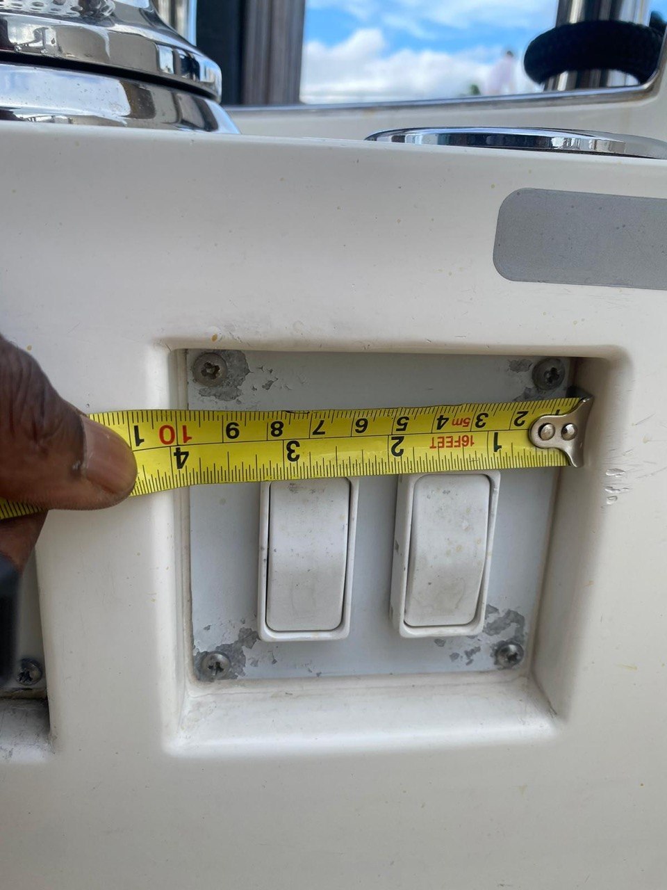 Tape measure across a switch panel cutout
