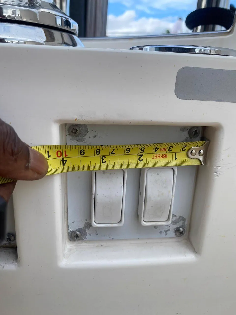 Tape measure across a switch panel cutout